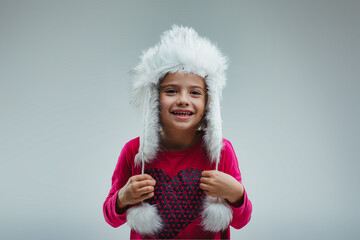Girl smiles, white fur hat, festive spirit