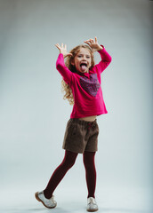 Spirited girl, pink sweater, playful expression shown