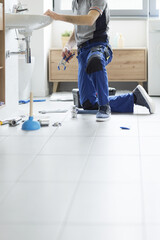Professional plumbing service: plumber fixing a sink