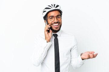 Young business latin man holding a bike helmet isolated on white background keeping a conversation...