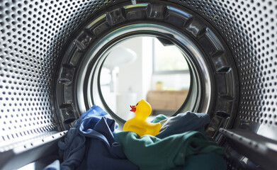 Clothes and rubber duck inside the washing machine
