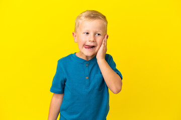 Little Russian boy isolated on yellow background with surprise and shocked facial expression
