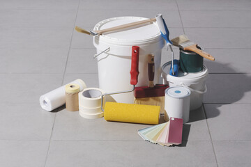Painting tools and paint buckets on the floor