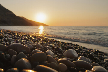 Obraz premium Pebbles on the beach at sunset. Low. angle, shallow depth of field.