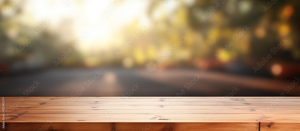 Poster An empty wooden table with a blurred abstract background providing ample copy space for text marketing promotions