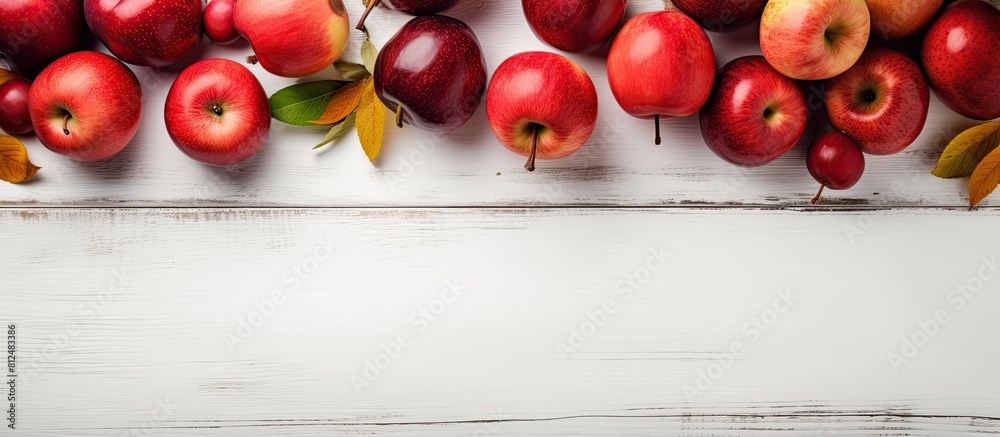 Poster An autumn harvest of Paradise apples is showcased in a top view displayed on a white wooden table along with a jar of sweet Paradise apple jam The composition allows for copy space in the image