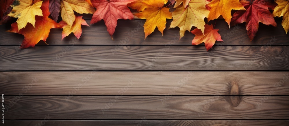 Aufkleber Top view of a wooden background with a composition of autumn leaves and ample space for text creating a copy space image