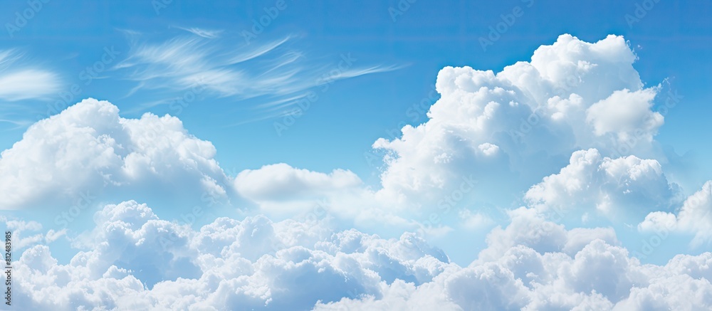 Aufkleber A wide background with a blue sky and fluffy clouds perfect for a summer template or backdrop image with copy space