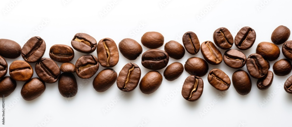 Poster A top view of coffee beans placed on a white surface creating an ideal copy space image