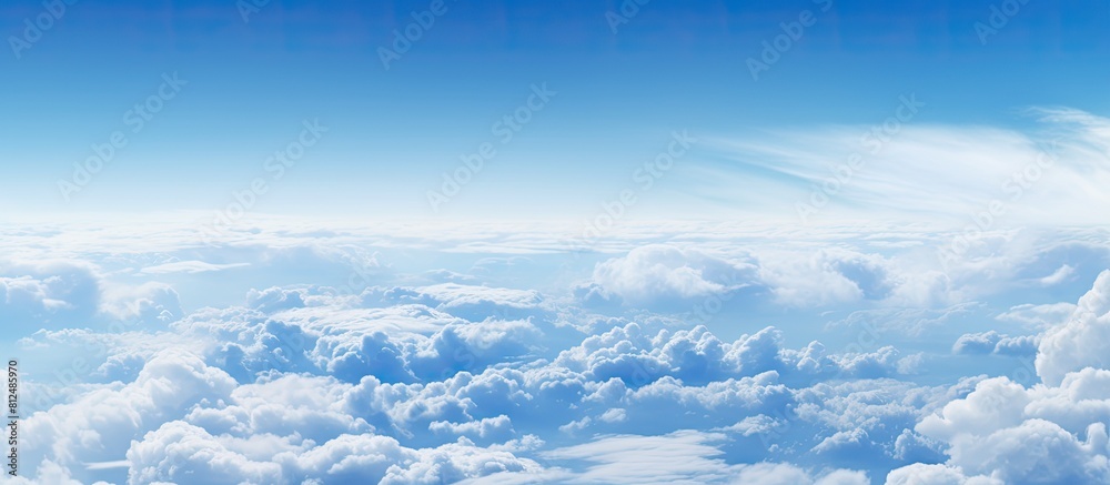 Wall mural a breathtaking sight of clouds fills the frame as seen from the window of an airplane creating a cap