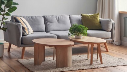 Two wooden coffee tables with plant in pot in front of grey corner sofa in fashionable living room interior,sofa, furniture, interior, couch, chair, room, armchair, leather, 