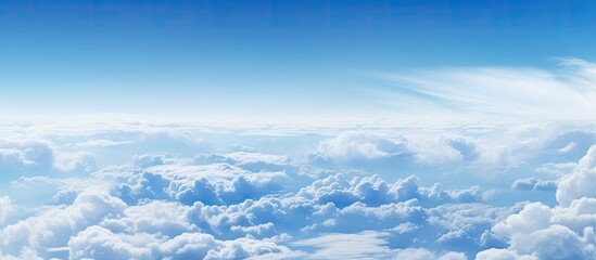 A breathtaking sight of clouds fills the frame as seen from the window of an airplane creating a captivating copy space image