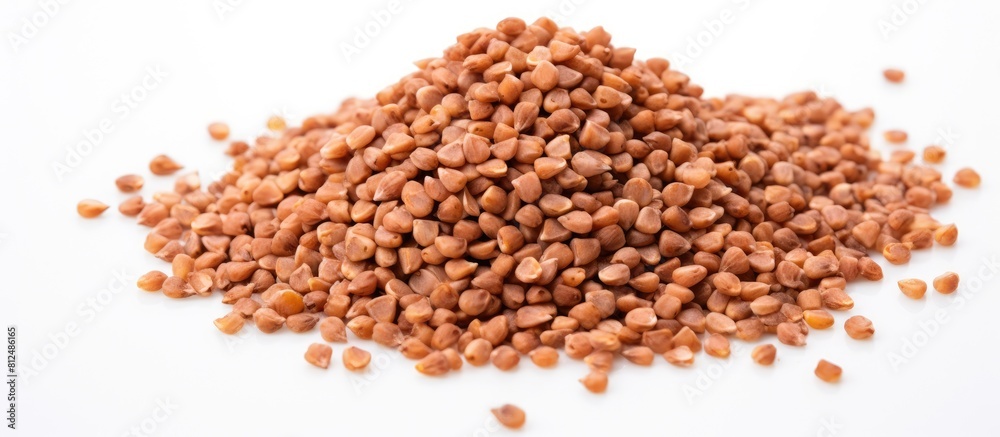 Aufkleber a bunch of healthy dried buckwheat grains on a white background with ample copy space in the image