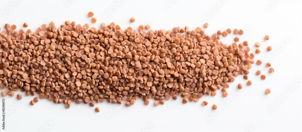 Poster a bunch of healthy dried buckwheat grains on a white background with ample copy space in the image