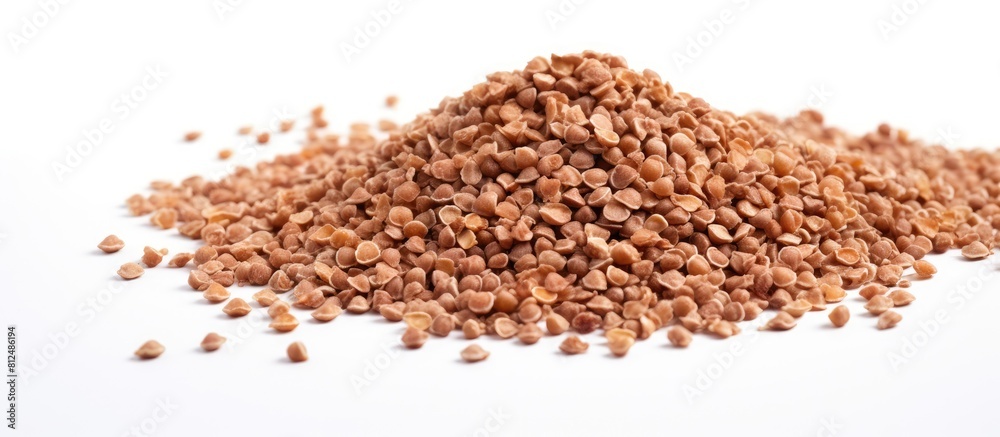 Poster a bunch of healthy dried buckwheat grains on a white background with ample copy space in the image
