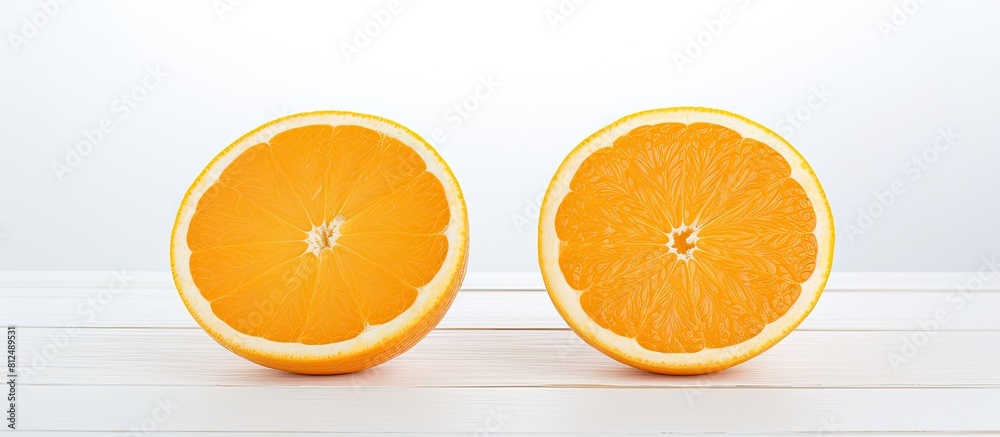 Poster the cut halves of two oranges are positioned on a white wooden table leaving empty space for an imag