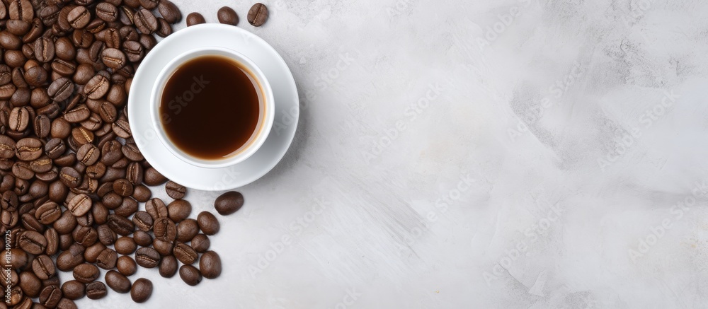 Aufkleber a top down view of a white cup filled with black coffee and coffee beans placed on a gray stone back