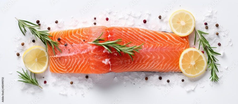 Poster a top down view of a raw salmon fillet seasoned with sea salt and rosemary placed on a white table w
