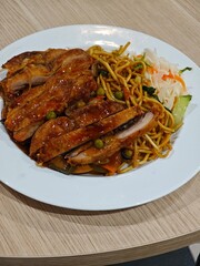 crispy chicken with teriyaki sauce and toasted noodles