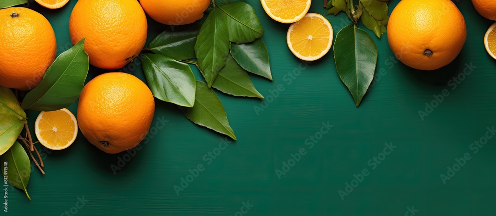 Aufkleber Top view of a composition featuring ripe oranges and leaves arranged on a colorful background leaving room for text in the copy space image
