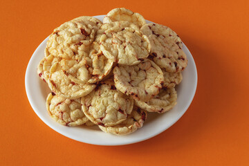 Potato chips with red beets on an orange background