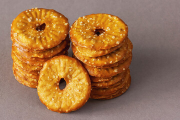 Two piles of round crackers with a hole and salt