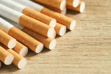 image of several commercially made cigarettes. pile cigarette on wooden. or Non smoking campaign...