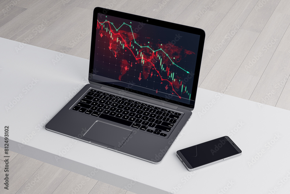 Poster close up of white office desk with smartphone and downward red forex chart on laptop screen. blurry 