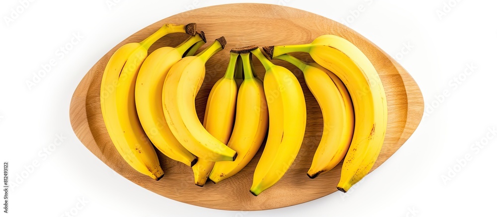 Poster a view from the top of ripe yellow bananas on a wooden plate with a white background this copy space