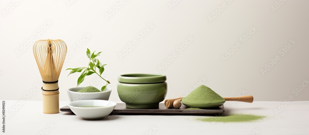 Poster a copy space image featuring matcha powder and tea ceremony tools arranged on a white background