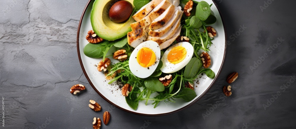 Poster copy space image of a keto friendly meal consisting of avocado slices grilled chicken quail eggs spi