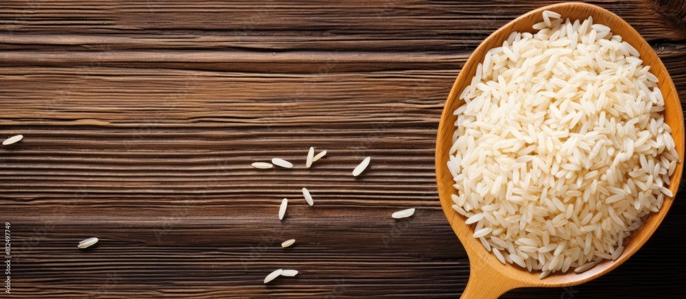 Poster a copy space image of rice with a spoon placed on a wooden background