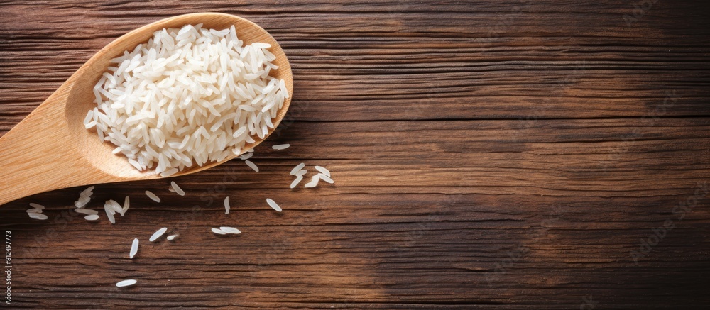Poster a copy space image of rice with a spoon placed on a wooden background