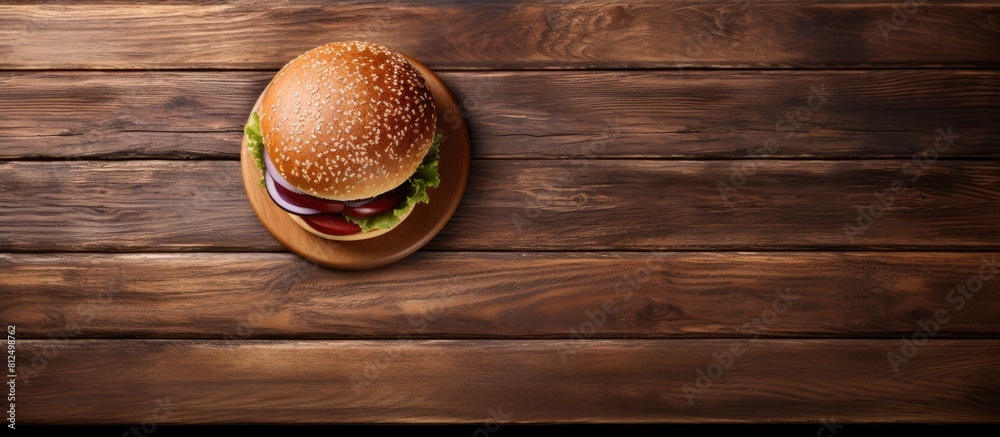 Poster the image shows a burger from a top view on a wooden table accompanied by a black tray offering ampl