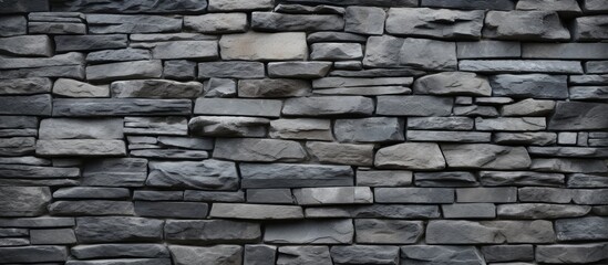 Fototapeta premium A background image of a textured gray stone wall with copy space