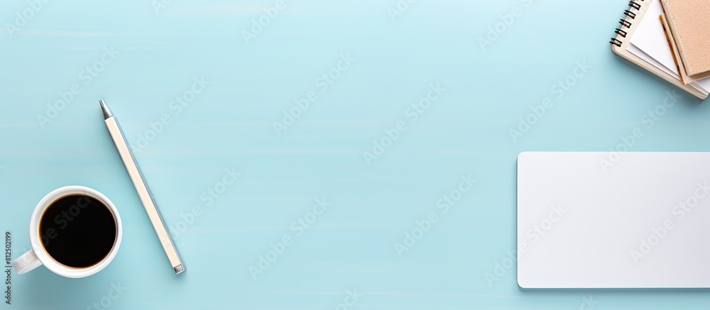 Fototapete A mockup photo of a working desk viewed from the top is displayed on a pastel blue background The desk features a tablet phone coffee cup and notebook with plenty of space for copy. Creative banner