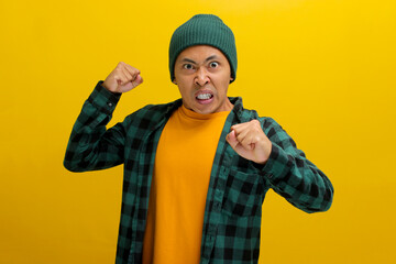 Young Asian man, wearing a beanie hat and casual outfit, is displaying aggression with a defensive...