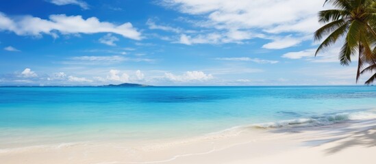 Obraz premium A picture of a perfect tropical beach with white sandy shores crystal clear turquoise waters and a vibrant blue sky as a copy space image