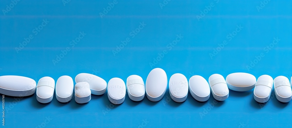 Poster Pills neatly arranged on a vibrant blue background providing ample copy space for additional content