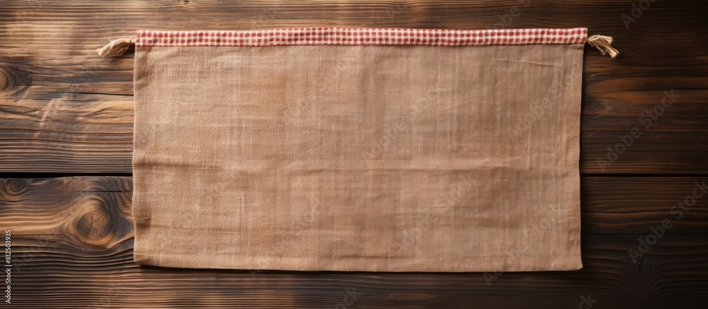 Poster Wooden cutting board with a kitchen cloth placed on a wood background creating an empty space for an image. Creative banner. Copyspace image