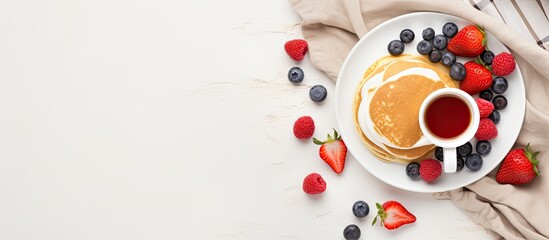 A romantic Valentine s Day breakfast concept with heart shaped pancakes fresh berries a cup of coffee and a rose on a white bed Top view copy space image