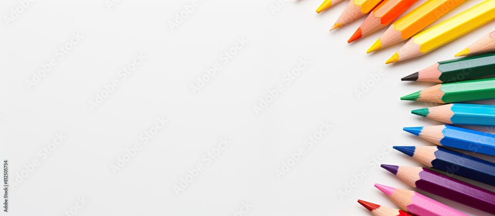 Poster A semicircle arrangement of colored watercolor pencils on a white background perfect for adding text or graphics Copy space image