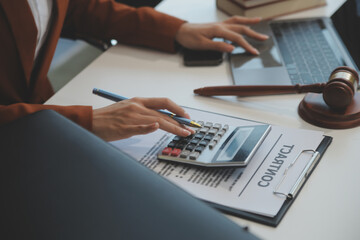 American woman lawyer or businesswoman African working with laptop, searching, analyzing data,...