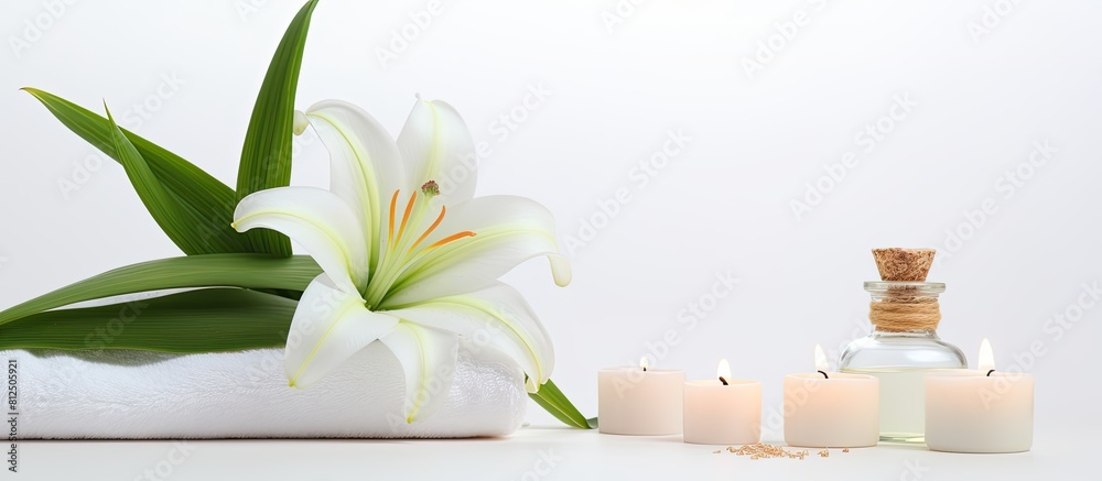 Aufkleber a serene wellness setting showcases a beautiful lily a towel a candle and an oil bottle on a white b