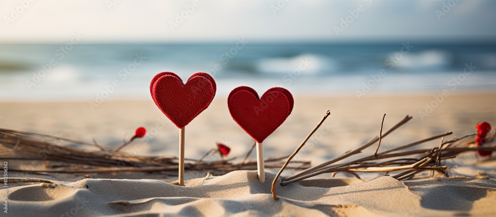 Poster two heart shaped cutouts in vibrant red color are attached to the tops of sticks creating a lovely a