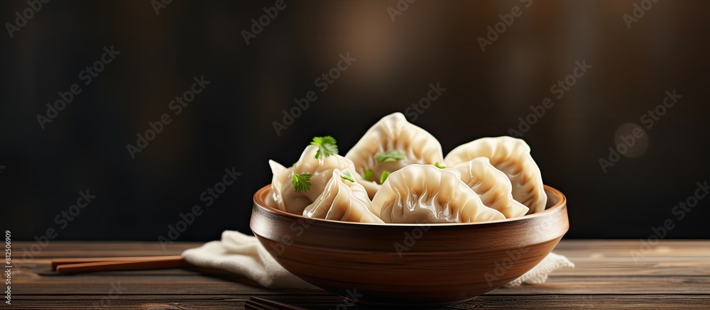 Poster a delicious bowl of dumplings sits on a wooden table with ample copy space for the image