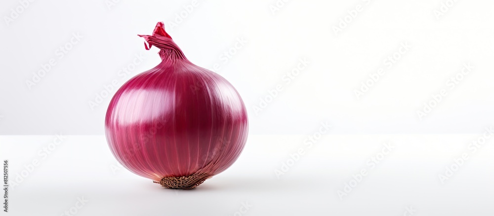 Poster a red onion stands alone on a white background in this copy space image