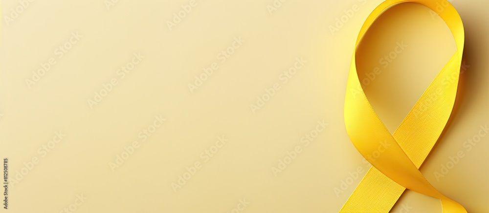 Aufkleber Top view of a yellow ribbon a symbolic image representing childhood cancer with ample copy space for text or graphics