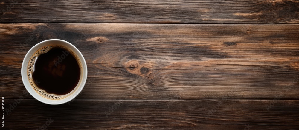 Aufkleber a top down perspective showing an old wooden surface with a cup of black coffee perfect for a copy s
