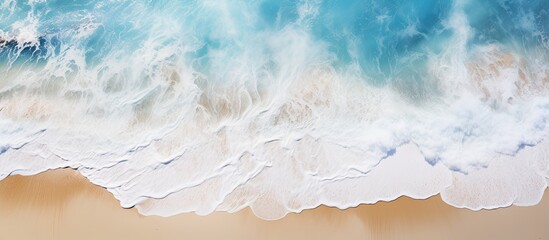 A top down view of an epoxy resin drawing depicting a sandy beach during summer The image shows an ocean wave with white foam serving as a background for a beach themed screensaver. Creative banner